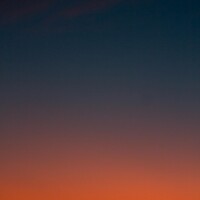 Fiery sunset with crescent moon Crescent moon and fiery orange sunset horizon